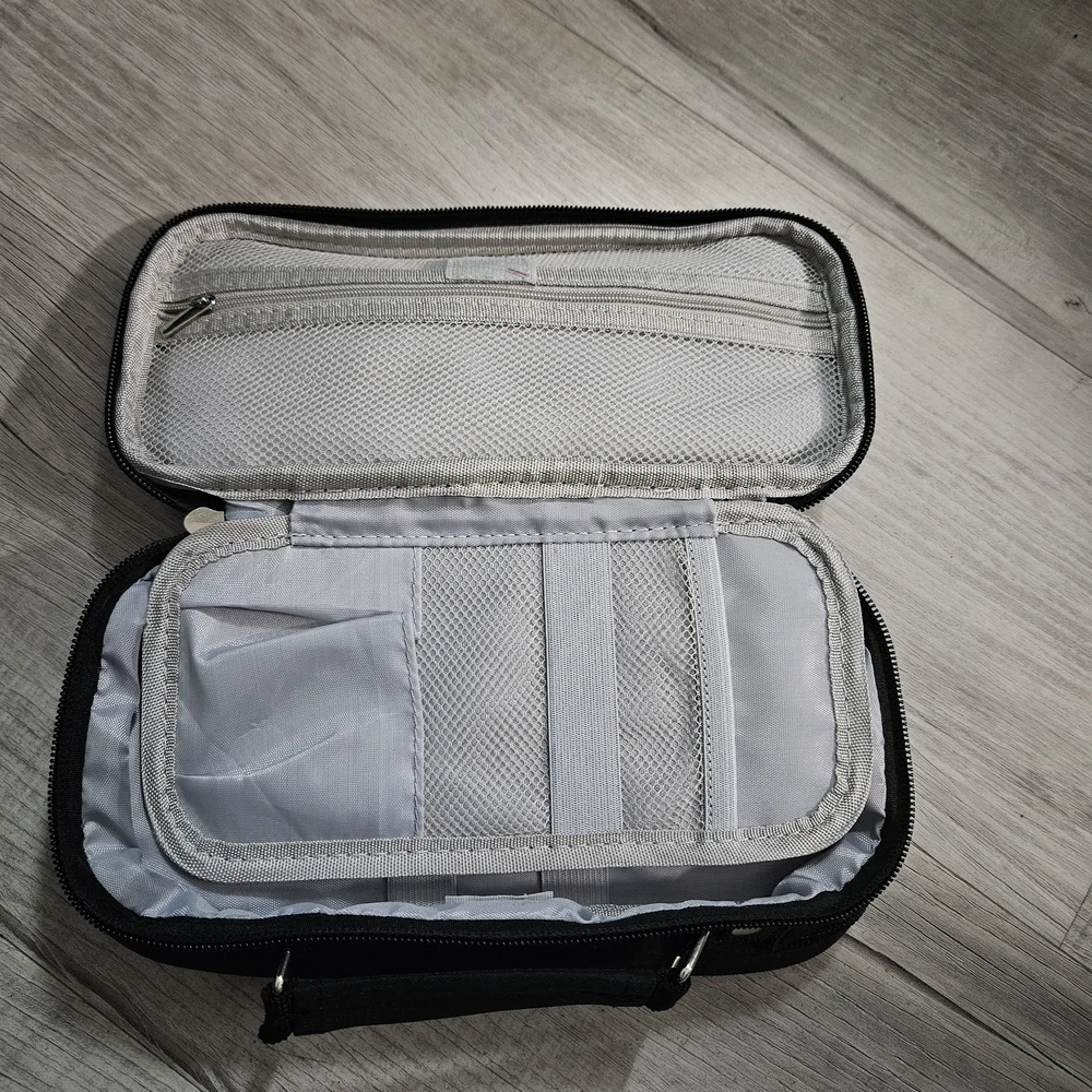 Torfly pencil case. Black with 2 zipper pouches and handle. Torly logo on front.